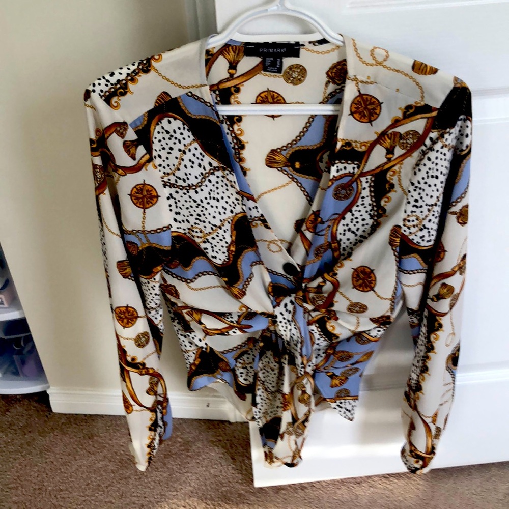 A really pretty blouse It buttons up and then wraps across.